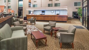 A lobby with a reception desk, seating area, and a patterned carpet. - Days Inn by Wyndham Kirksville (Kirksville)