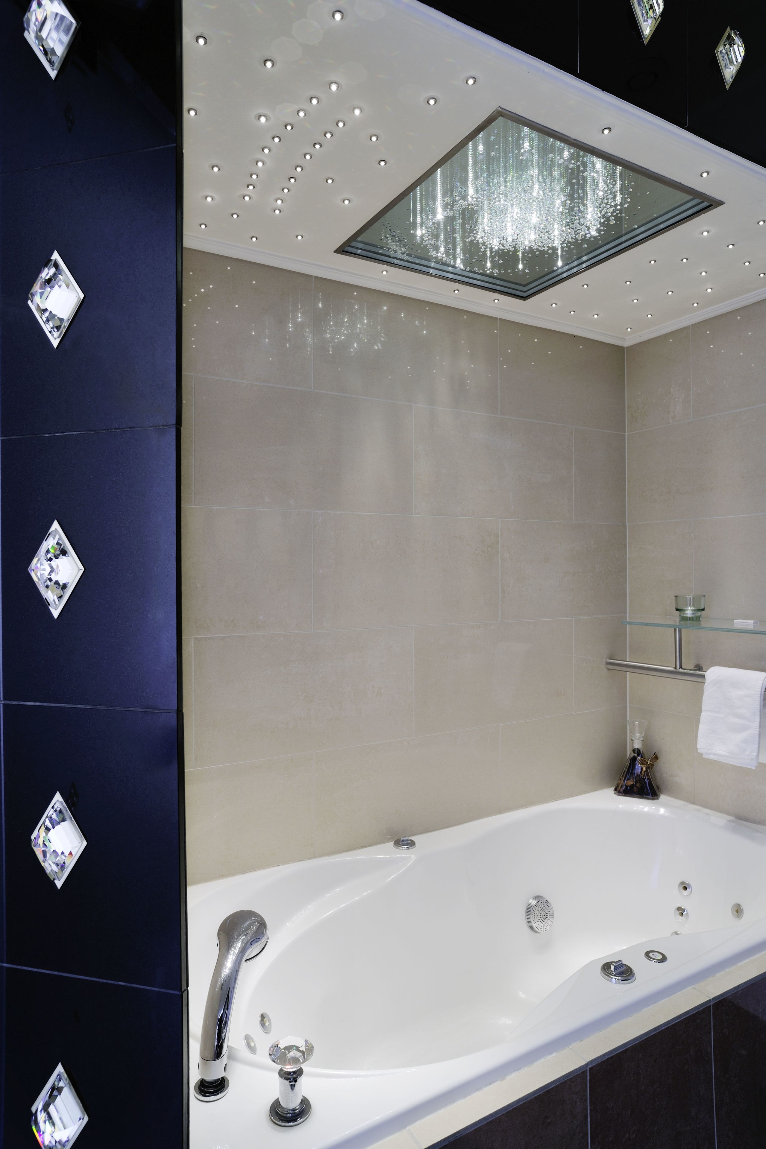 A modern bathroom with a freestanding bathtub, a glass-enclosed shower, and a mirror above the tub.
