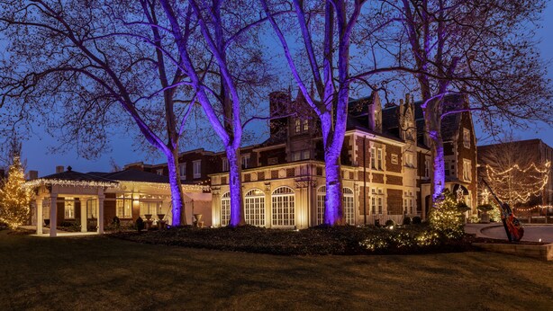 A large, historic building with multiple windows and a well-maintained lawn. - The Glidden House (Cleveland)