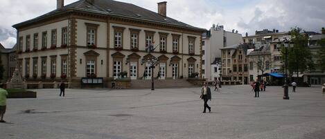 A large, historic building with a symmetrical facade, large windows, and a central entrance.