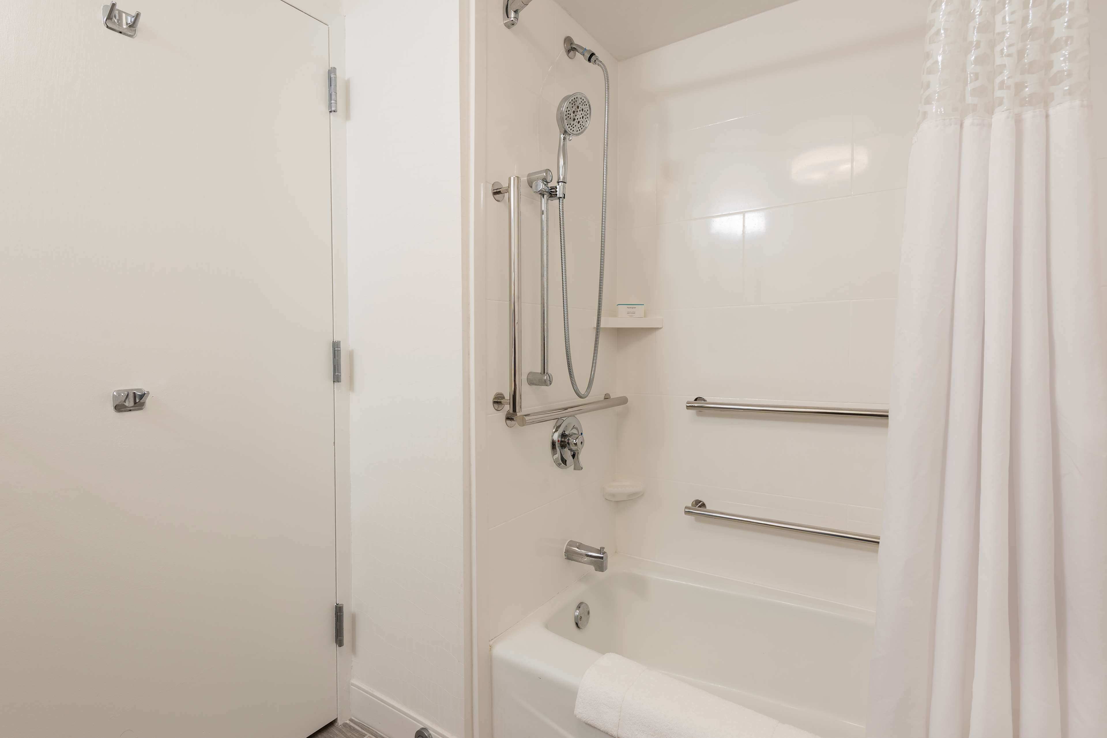 A modern bathroom with a shower, a bathtub, and a toilet.