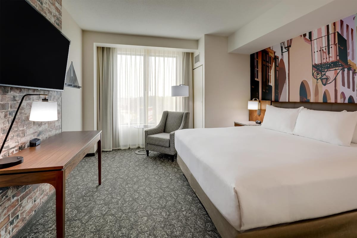 Premium bedding, desk, laptop workspace, blackout drapes