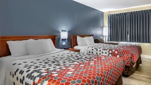 A hotel room with two beds, a nightstand, a lamp, and a window with curtains. - Econo Lodge Erlanger - Cincinnati Airport (Erlanger)