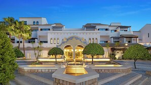 A hotel with a central courtyard, multiple floors, and a distinctive entrance with arches. - Pine Cliffs Hotel, a Luxury Collection Resort, Algarve (Albufeira)