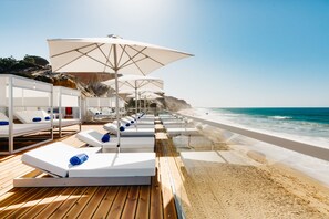A la platja, gandules de platja i para-sols per a la platja 