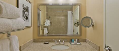 A bathroom with a sink, mirror, towel rack, and a framed picture on the wall.