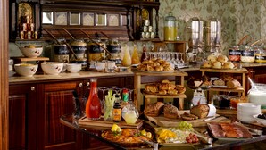 A buffet with various food items, including bread, pastries, and a selection of cheeses and fruits. - Glenlo Abbey Hotel (Galway)