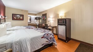A hotel room with two beds, a desk, a television, and a minibar. - Red Roof Inn Merrillville (Merrillville)