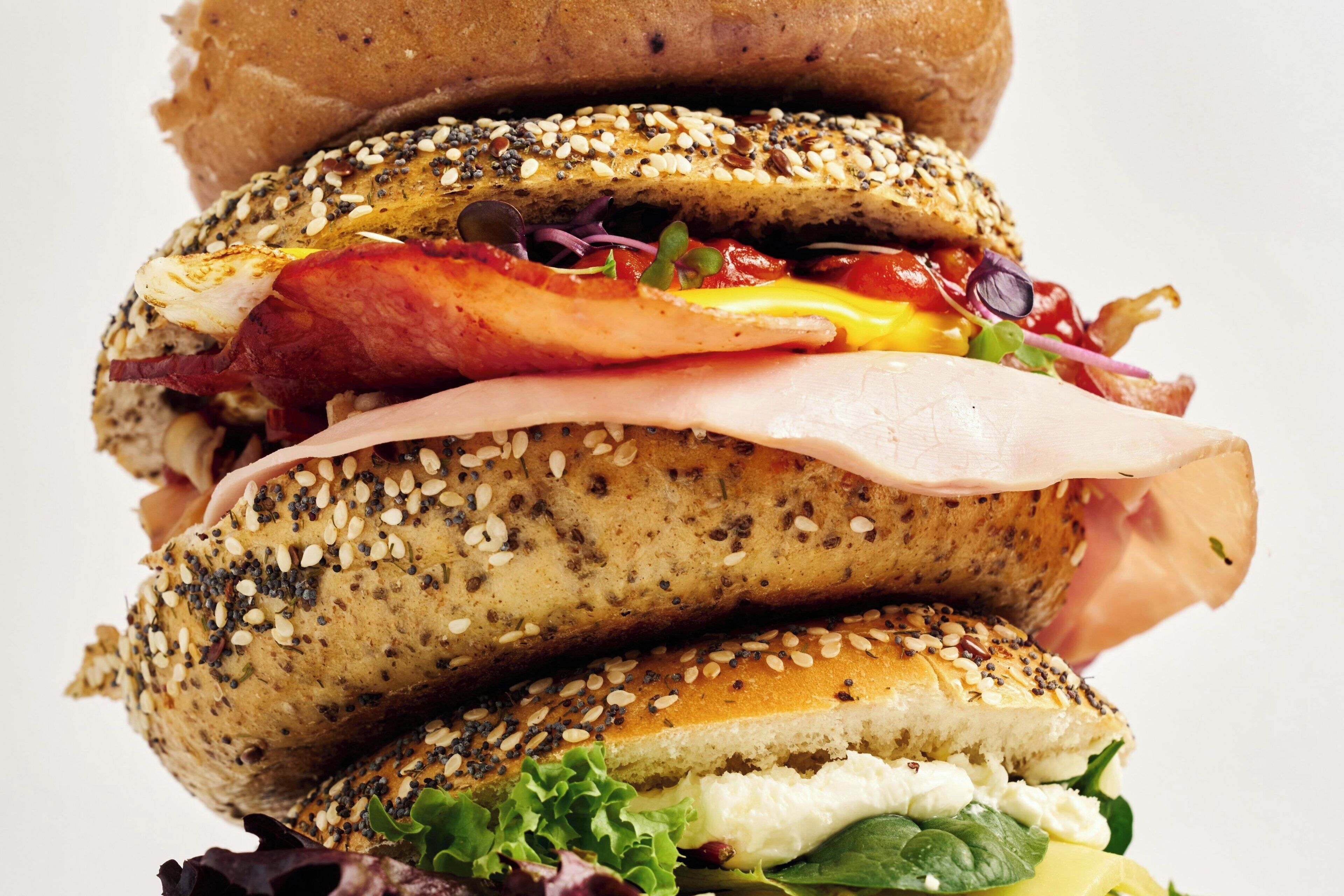 A multi-layered sandwich with various ingredients.