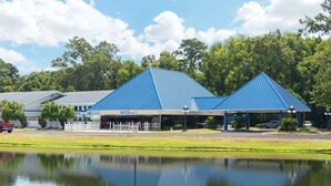 A building with a blue roof and a covered area in front. - Days Inn by Wyndham Savannah Airport (Garden City)