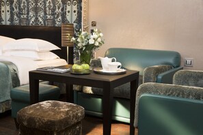 Relax in a cozy seating area with a comfortable bed and elegant decor.