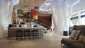 A modern interior with a bar area, seating, and unique ceiling design. - Scandic Copenhagen (Copenhagen)