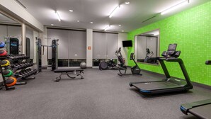 A gym with treadmills, a weight bench, and various exercise equipment. - La Quinta Inn & Suites by Wyndham Middletown-Goshen (Middletown)