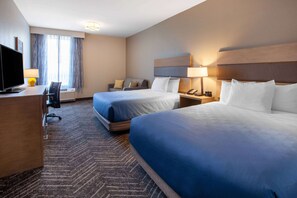 A hotel room with two beds, a desk, a TV, and a lamp. - La Quinta Inn & Suites by Wyndham Middletown-Goshen (Middletown)