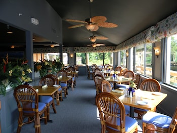 A hotel lobby with a reception desk, potted plants, and a sign for Hilton Head Island Beach Resort. at Hilton Head Island Beach & Tennis Resort