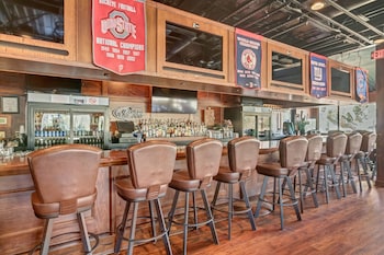 A wooden deck with a glass-enclosed structure, likely a lounge or waiting area, with a clear view of the surrounding buildings and palm trees. at Hilton Head Island Beach & Tennis Resort