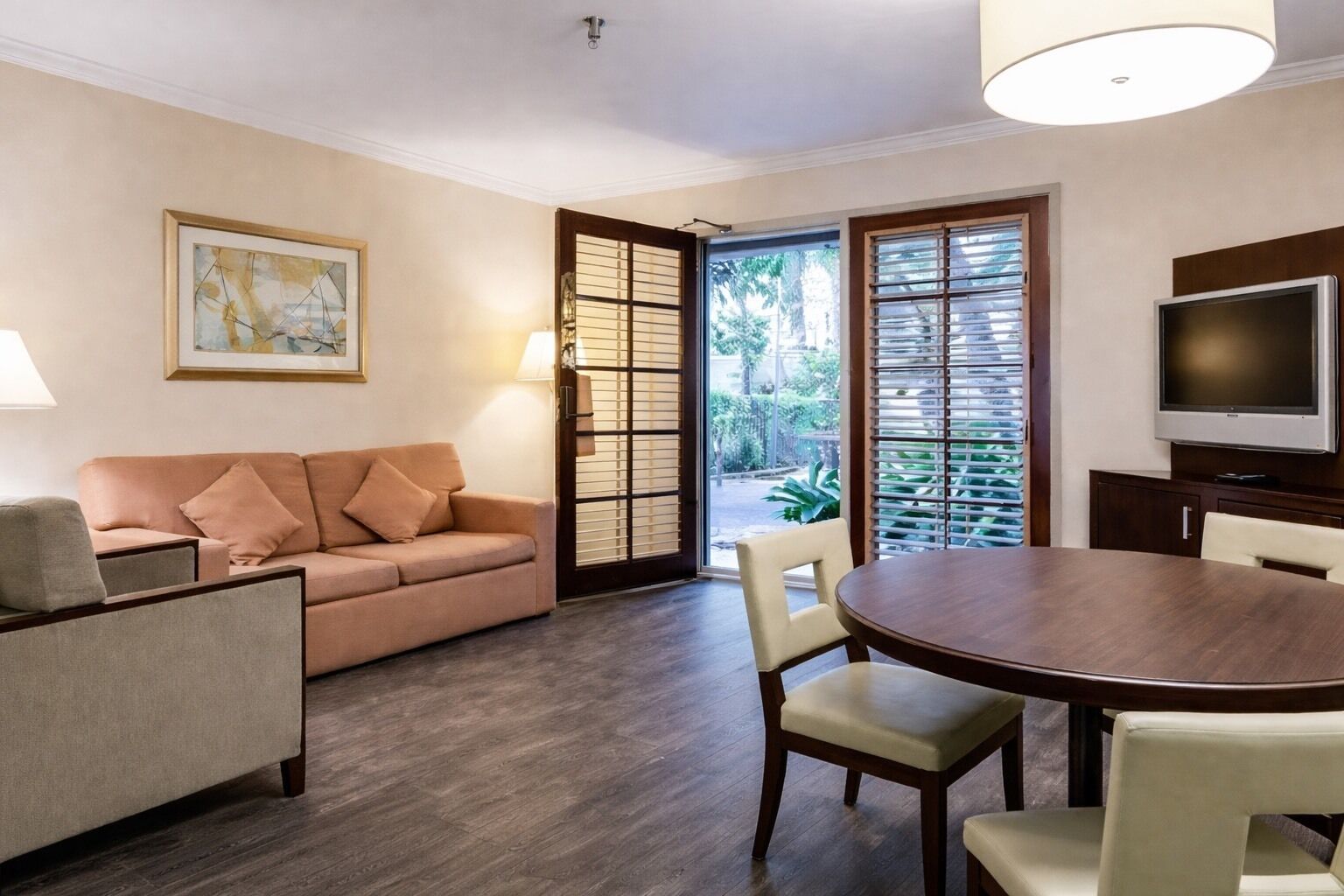 Suite, 1 King Bed with Sofa bed (Courtyard View) | Living area | 32-inch flat-screen TV with cable channels, TV