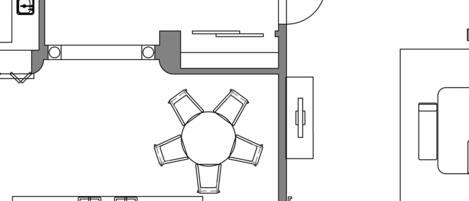 A hotel floor plan with a central dining area, multiple bedrooms, a kitchen, and a bathroom.