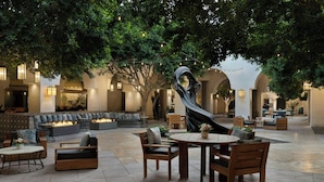 An outdoor lounge area with seating, a fire feature, and string lights. - The Westin Rancho Mirage Golf Resort & Spa (Rancho Mirage)