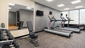 A gym with treadmills, a bench press, and dumbbells. - Fairfield Inn by Marriott Philadelphia West Chester/Exton (Exton)