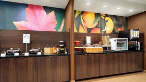 A hotel reception area with a counter, coffee machines, and a fruit display. - Fairfield Inn by Marriott Philadelphia West Chester/Exton (Exton)