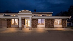 A modern two-story house with large windows, a garage, and a covered entryway. - Days Inn by Wyndham Fond du Lac (Fond du Lac)