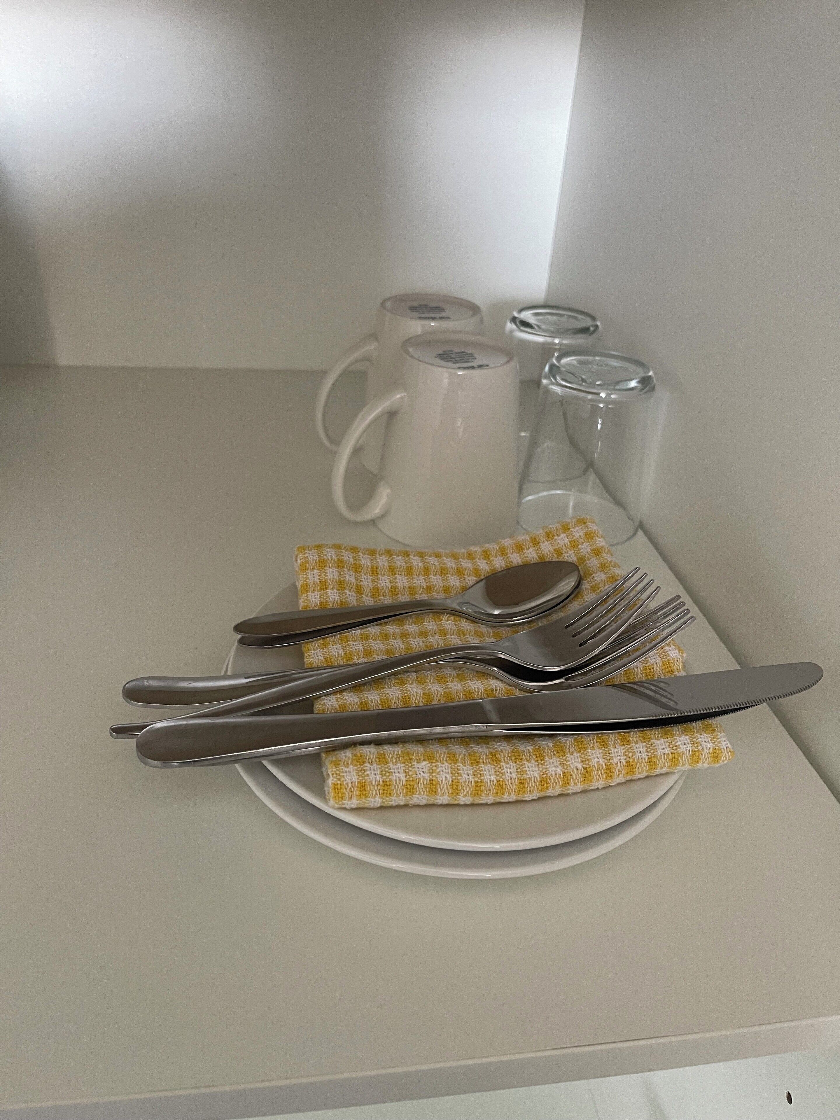 A table set with a plate, cutlery, and a napkin.