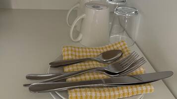 A table set with a plate, cutlery, and a napkin.