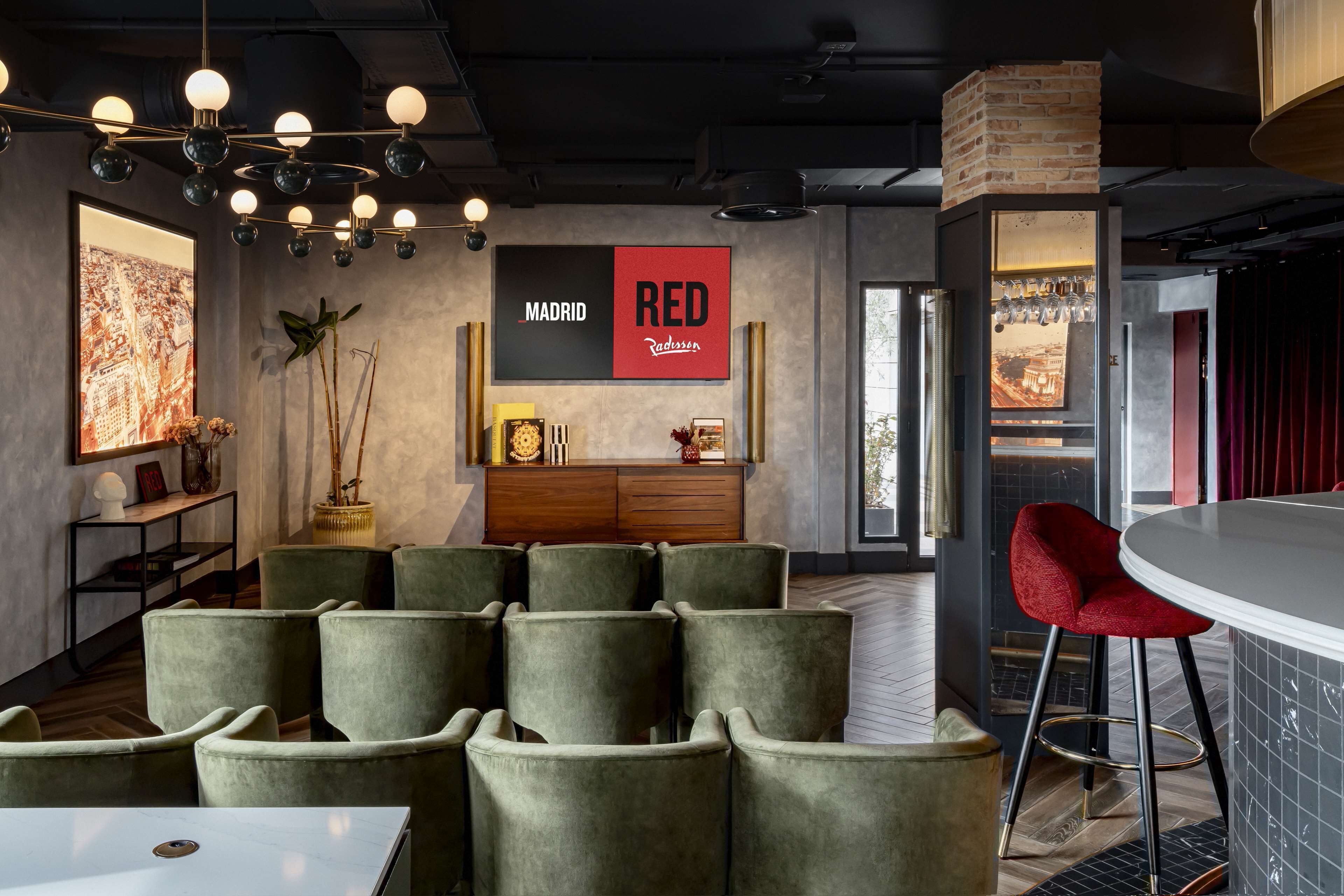 A modern interior with a bar area, seating, and a cityscape artwork.