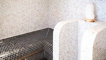 Unique tile design adorns the walls, complemented by a curved bench and a striking floor pattern.