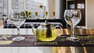 A table with two Lockley glasses, a teapot, and a menu.