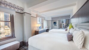 A hotel room with two beds, a desk, a chair, a window with a city view, and a decorative wall panel. - Park Central Hotel New York (New York)