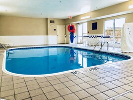 An indoor swimming pool with a 'NO DIVING' sign, tiled floor, and a pool lift.