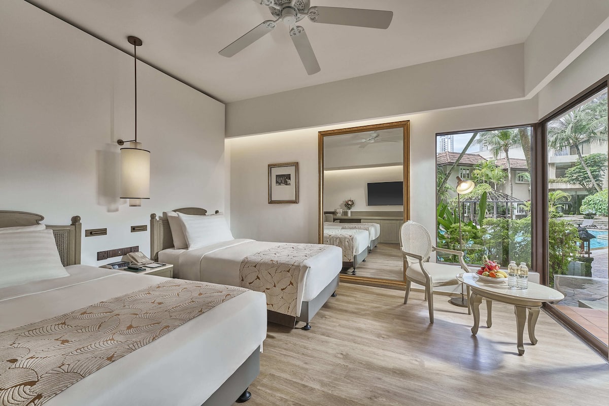 Deluxe Poolside Room | In-room safe, desk, iron/ironing board, free cribs/infant beds