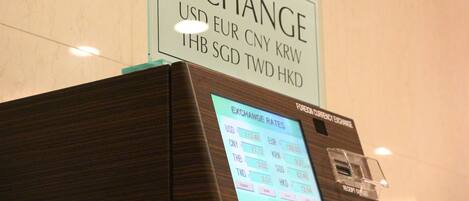 An exchange rate display board in a hotel lobby.