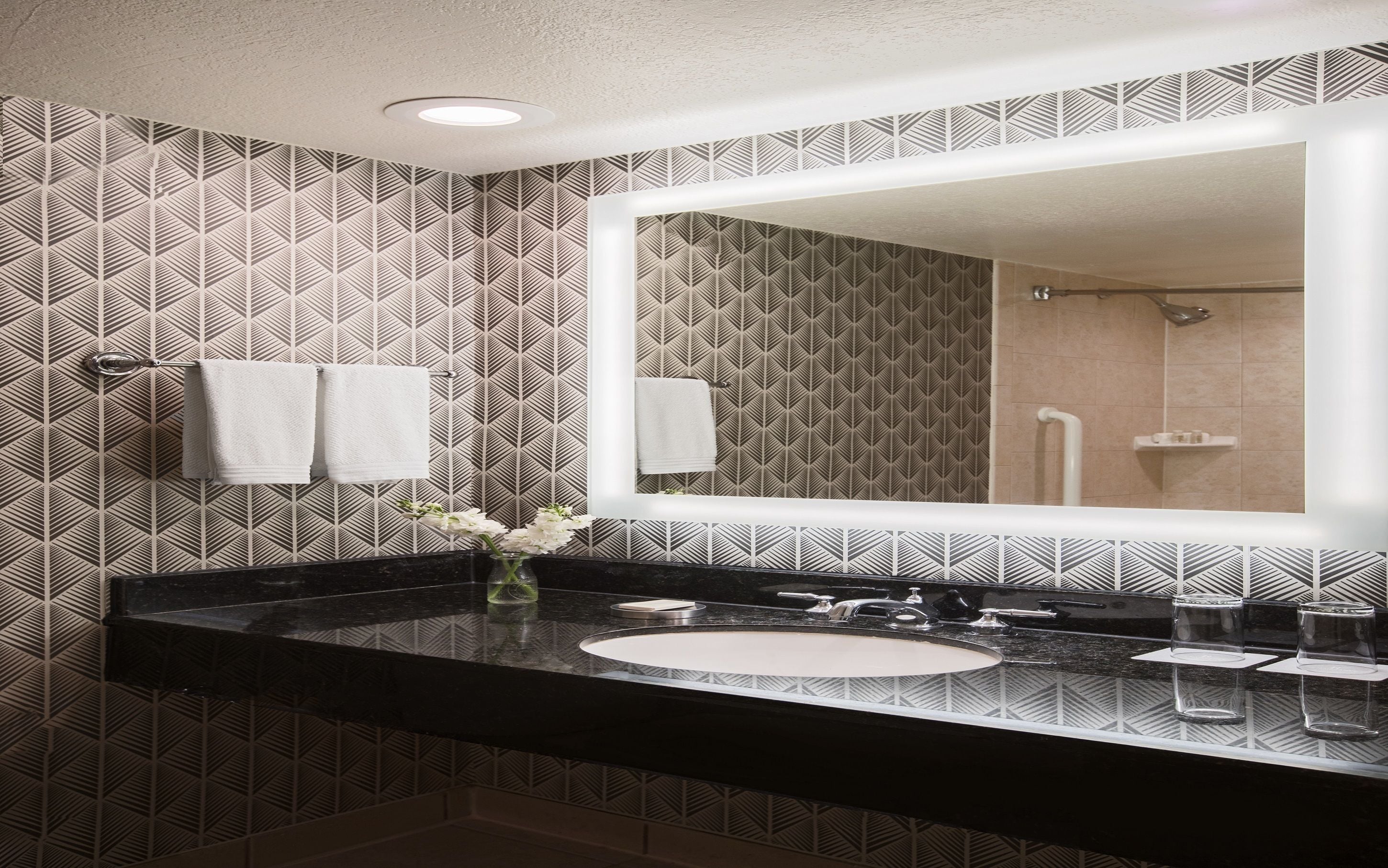 combined shower/bathtub, designer toiletries, hair dryer, towels