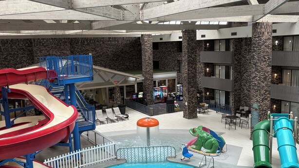 An indoor water park with slides and a pool.
