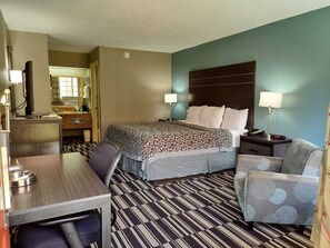 Relax in a stylish room with a large bed, desk, and television.