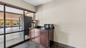 A modern kitchen with a built-in microwave, a refrigerator, and a coffee machine. - Red Roof Inn Washington, DC (Washington)