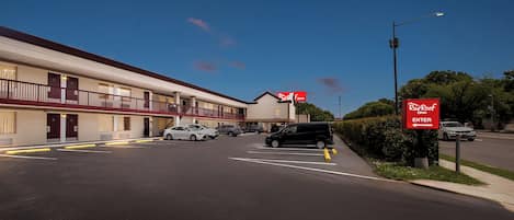 A Red Roof Inn with a two-story building, a parking lot, and a street view.