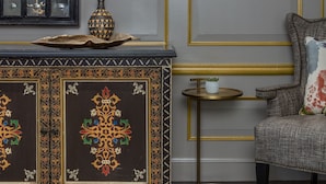 A room with a decorative console table, a vase, a small potted plant, and a chair with a cushion. - The Alexandrian Old Town Alexandria, Autograph Collection (Alexandria)