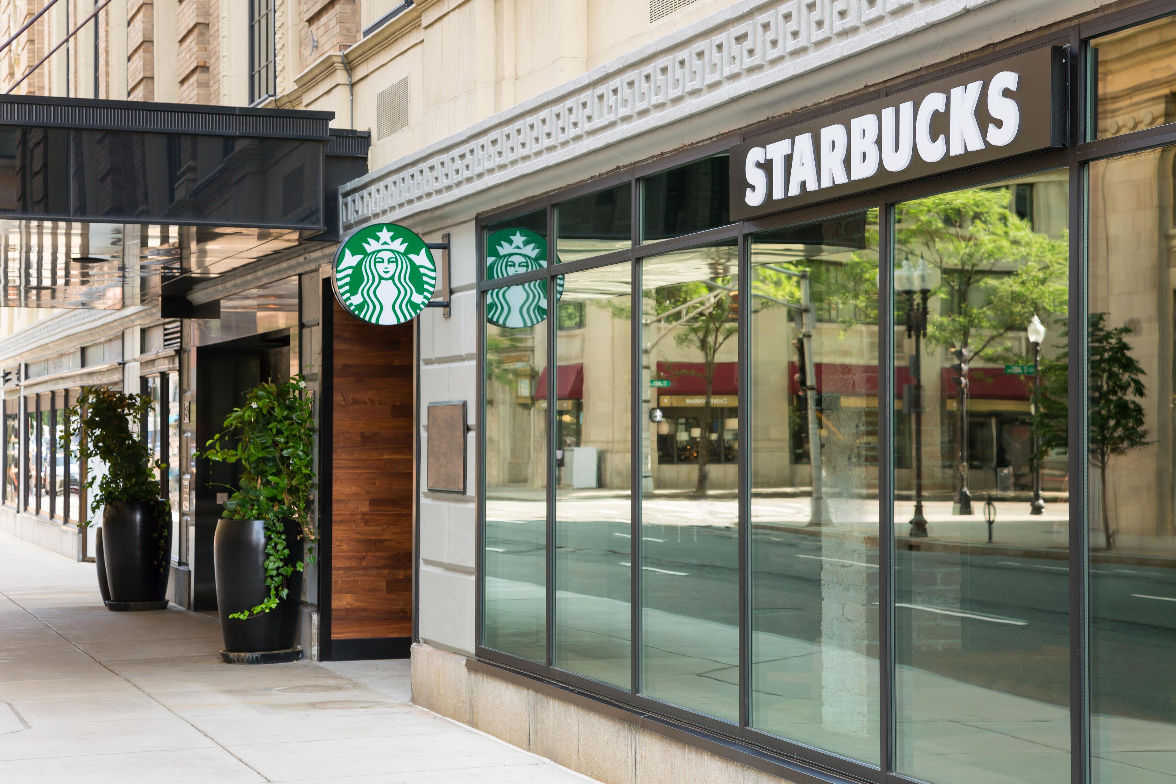 A Starbucks storefront with large windows and a sign above the entrance.