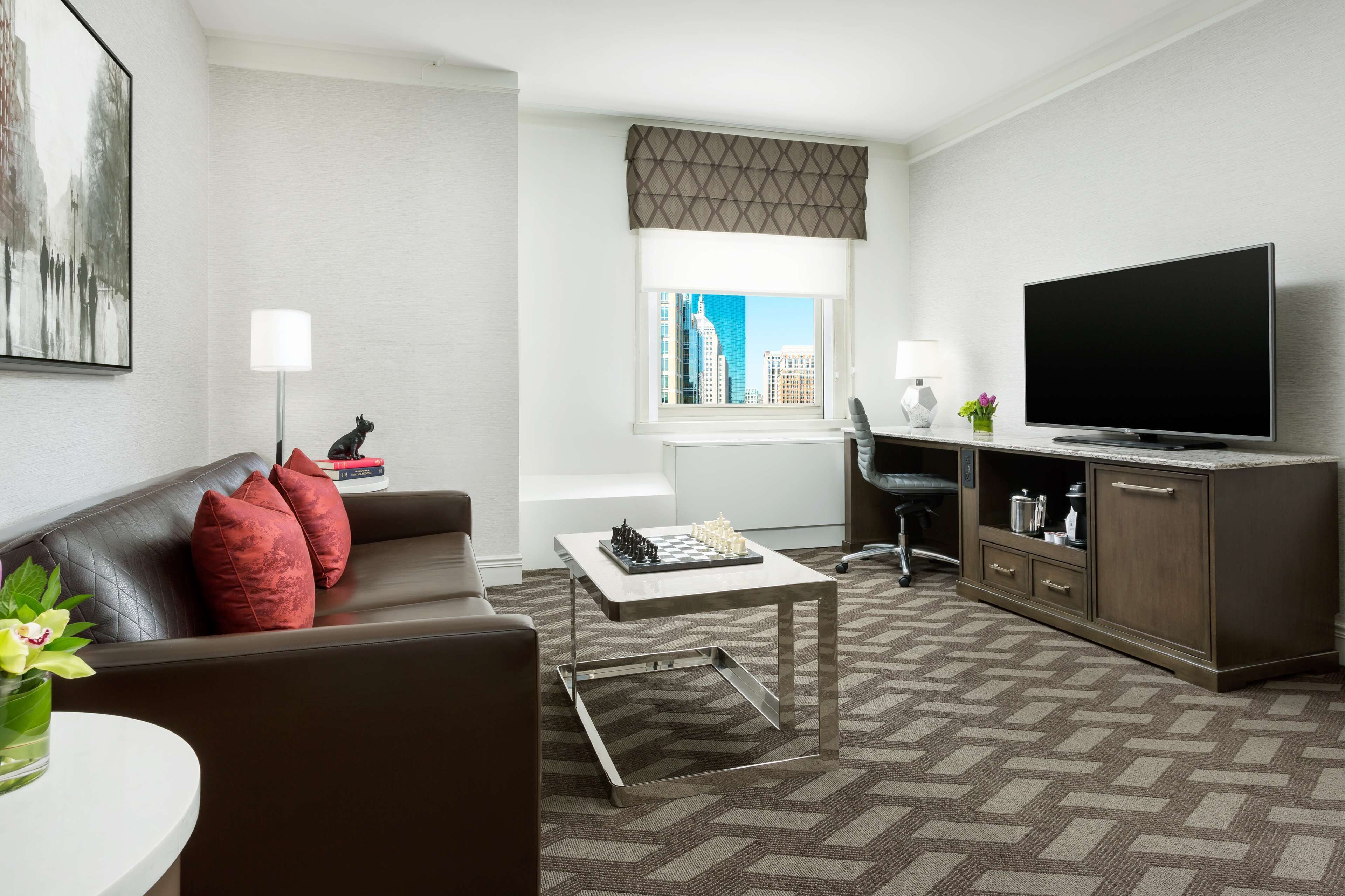 A modern living room with a sofa, coffee table, and a flat-screen TV.