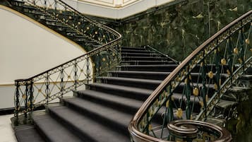 A grand staircase with ornate metal railings and marble steps.