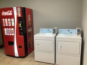 A vending machine with a Coca-Cola logo and a Whirlpool appliance. - Red Roof Inn Amarillo West (Amarillo)