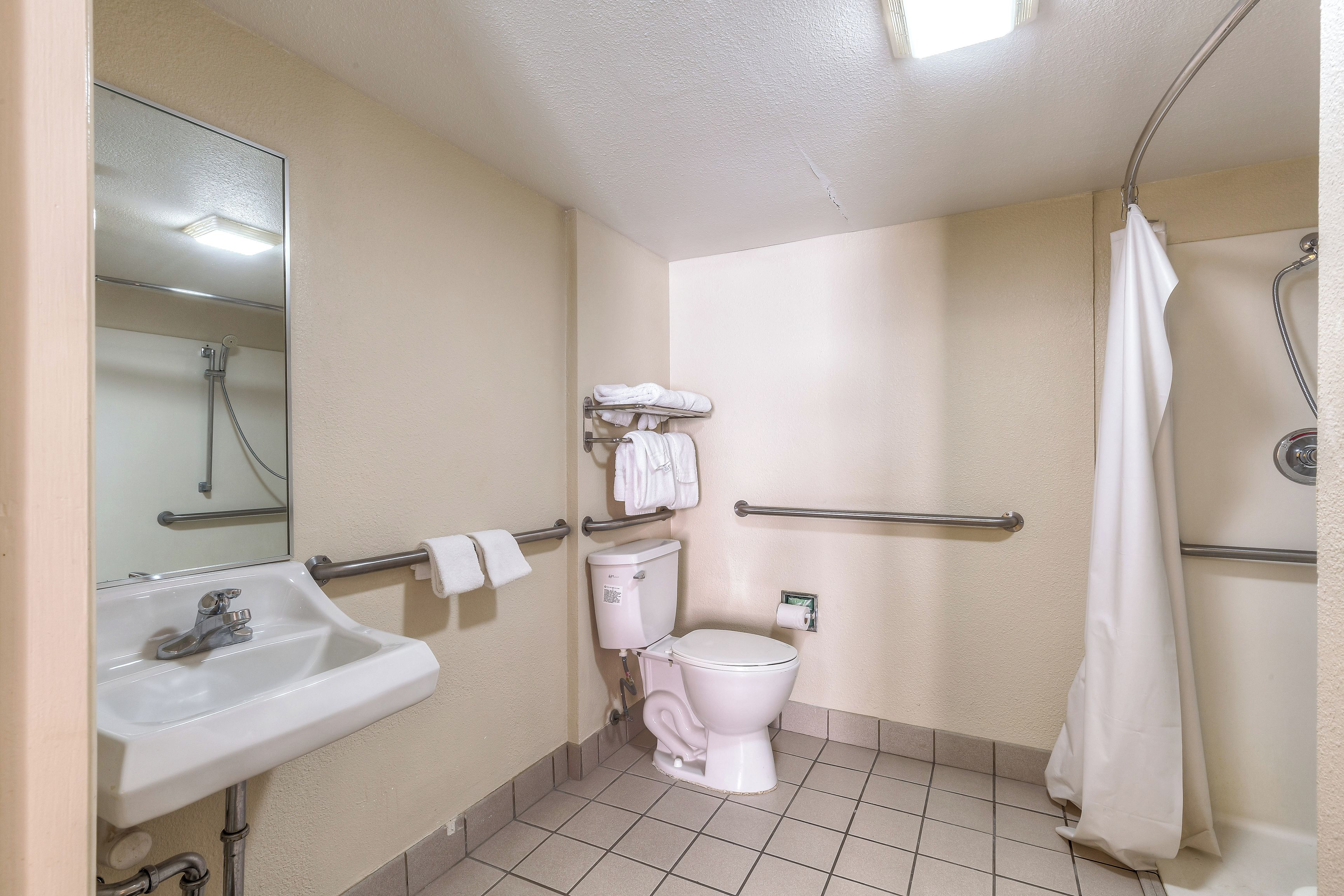 Un baño pequeño y funcional con lavamanos, inodoro y ducha.