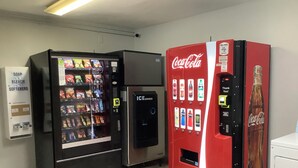 A vending machine area with a soap and bleach softener dispenser, an ice dispenser, and a Coca-Cola vending machine. - Red Roof Inn Amarillo West (Amarillo)