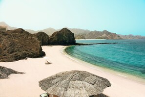 Private beach, sun loungers, beach umbrellas, beach towels - Al Bustan Palace, a Ritz-Carlton Hotel (Muscat)