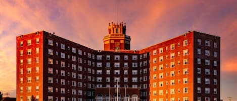 A large, multi-story hotel with a central tower and a symmetrical facade.