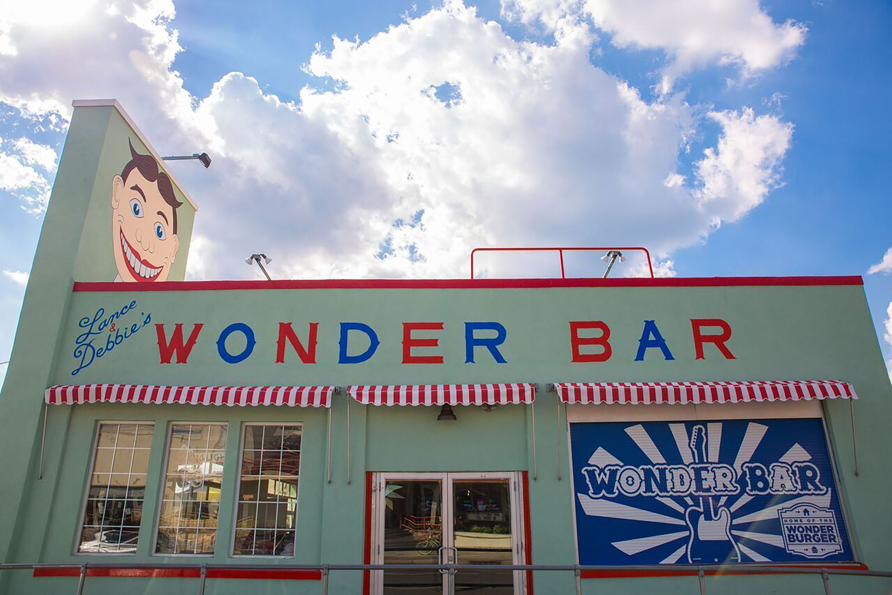 A building with a sign reading "Wonder Bar" and a large cartoon character on the side.